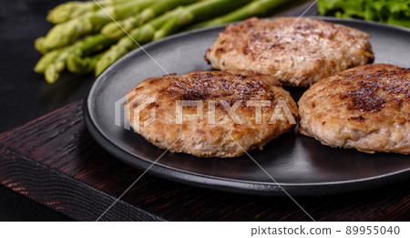Flat lay composition with grilled meat cutlets for burger on black concrete table Flat lay composition with grilled meat cutlets for burger on black concrete table 89955040