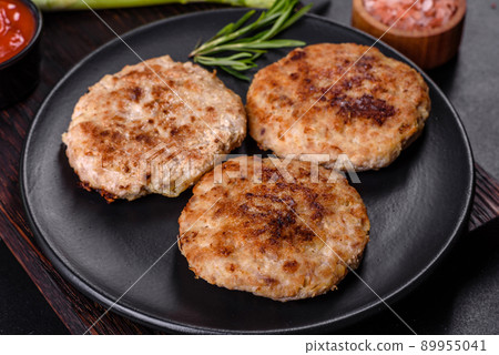 Flat lay composition with grilled meat cutlets for burger on black concrete table Flat lay composition with grilled meat cutlets for burger on black concrete table 89955041