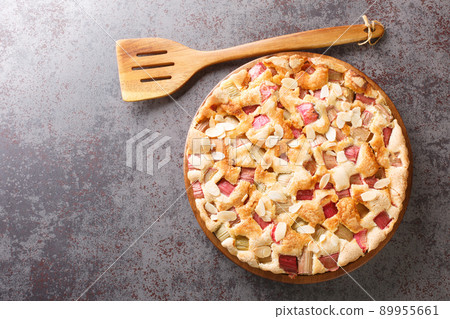 Sweet and sour delicious rhubarb pie with almonds close-up in a dish. horizontal top view 89955661