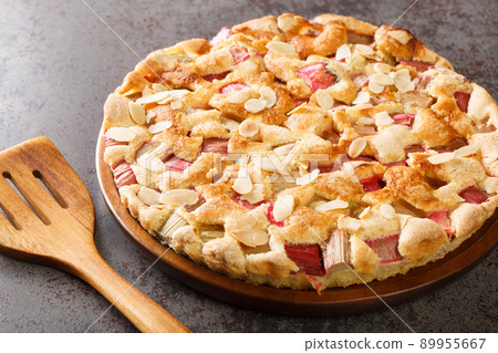 Sweet and sour delicious rhubarb pie with almonds close-up in a dish. horizontal 89955667