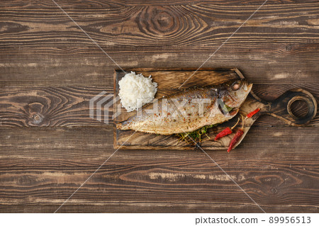 Baked sea yellow tailed lacedra on wooden cutting board 89956513