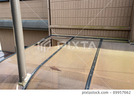 Old, dirty and perforated carport roof 89957662