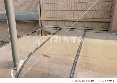 Old, dirty and perforated carport roof 89957663