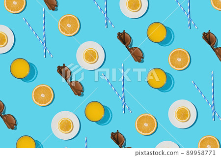 Summer pattern on a bright blue pastel background sunlight fruity orange and sunglasses. Summer pattern on a bright blue pastel background sunlight fruity orange and sunglasses. 89958771