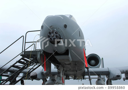 Gatling gun on the nose of a parked A-10 attack aircraft Gatling gun on the nose of a parked A-10 attack aircraft 89958860