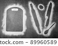 Baking dark background with the outlines of ingredient flour cutting board, rolling pin, spoon and knife flatlay with copy space. 89960589