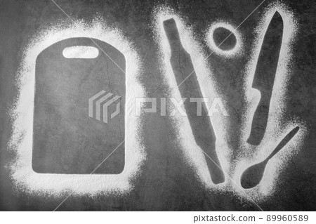 Baking dark background with the outlines of ingredient flour cutting board, rolling pin, spoon and knife flatlay with copy space. 89960589