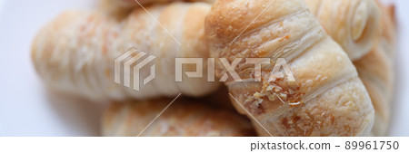 Hot delicious sausages in dough on a plate, puff bun 89961750