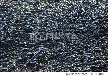 wet dark pebbles and rocks on the ocean coast. black reynisfjara beach in Iceland wet dark pebbles and rocks on the ocean coast. black reynisfjara beach in Iceland 89963089