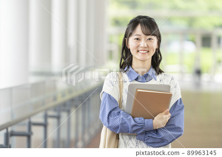 Image of a young female college student smiling looking at the camera 89963145
