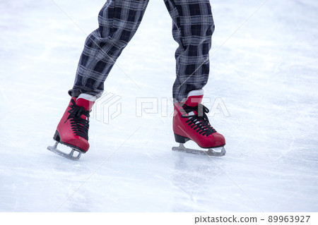 feet on skates on an ice rink. winter sport and recreation feet on skates on an ice rink. winter sport and recreation 89963927