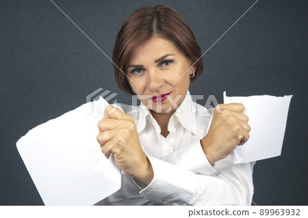 Beautiful business woman tearing white paper in half 89963932