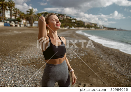 Young attractive female breathing fresh air at sea 89964036