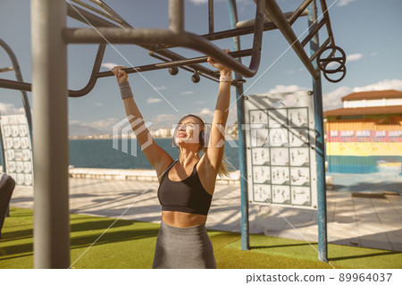 Shot of attractive sportswoman during morning exercise outdoors 89964037
