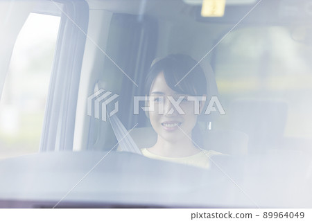 A young woman driving a car A young woman driving a car 89964049