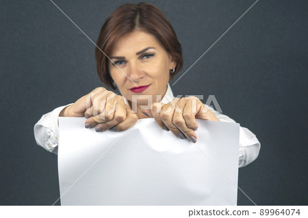 Beautiful business woman tearing white paper in half 89964074