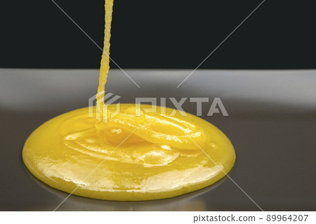 Fresh viscous floral honey flows onto the plate. vitamin organic food 89964207