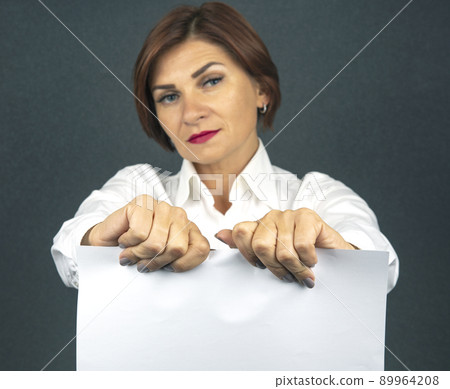 Beautiful business woman tearing white paper in half 89964208