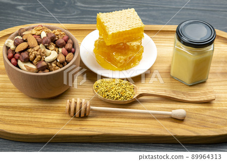 assortment of nuts and assorted dried citrus fruits and fresh floral honeycomb honey assortment of nuts and assorted dried citrus fruits and fresh floral honeycomb honey 89964313