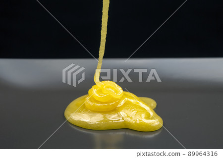Fresh viscous floral honey flows onto the plate. vitamin organic food Fresh viscous floral honey flows onto the plate. vitamin organic food 89964316