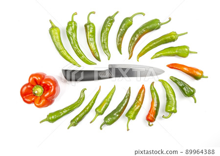 ceramic knife and green hot peppers on a white background. cooking vegetables for food ceramic knife and green hot peppers on a white background. cooking vegetables for food 89964388