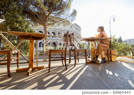 Woman at outdoor cafe near Coliseum in Rome, Italy Woman at outdoor cafe near Coliseum in Rome, Italy 89965445