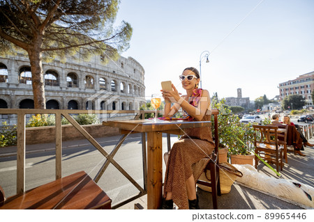 Woman at outdoor cafe near Coliseum in Rome, Italy Woman at outdoor cafe near Coliseum in Rome, Italy 89965446