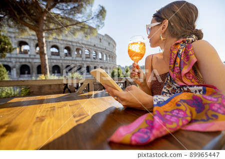 Woman at outdoor cafe near Coliseum in Rome, Italy Woman at outdoor cafe near Coliseum in Rome, Italy 89965447