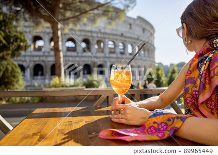 Woman at outdoor cafe near Coliseum in Rome, Italy 89965449