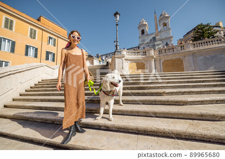 Woman running with her dog on famous Spanish steps in Rome Woman running with her dog on famous Spanish steps in Rome 89965680
