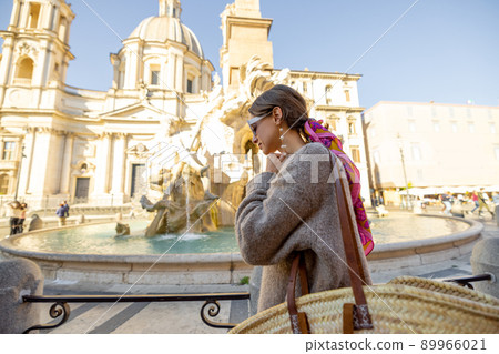 Woman walks on Piazza del Popolo in Rome city on a morning time Woman walks on Piazza del Popolo in Rome city on a morning time 89966021
