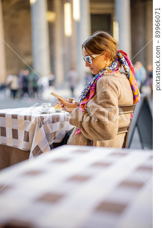 Woman sitting at outdoor cafe near Panthenon temple in Rome Woman sitting at outdoor cafe near Panthenon temple in Rome 89966071