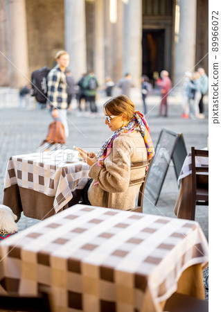Woman sitting at outdoor cafe near Panthenon temple in Rome Woman sitting at outdoor cafe near Panthenon temple in Rome 89966072