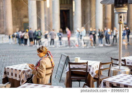 Woman sitting at outdoor cafe near Panthenon temple in Rome Woman sitting at outdoor cafe near Panthenon temple in Rome 89966073