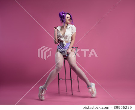 sexy schoolgirl girl with purple hair in summer short clothes and beautiful underwear on a pink background 89966259