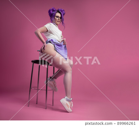 sexy schoolgirl girl with purple hair in summer short clothes and beautiful underwear on a pink background sexy schoolgirl girl with purple hair in summer short clothes and beautiful underwear on a pink background 89966261