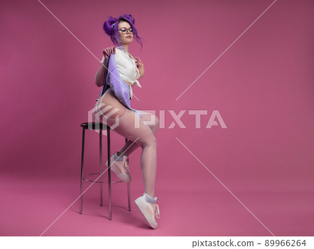 sexy schoolgirl girl with purple hair in summer short clothes and beautiful underwear on a pink background 89966264