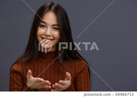 young woman hand gestures brown sweater fashion isolated background young woman hand gestures brown sweater fashion isolated background 89966713