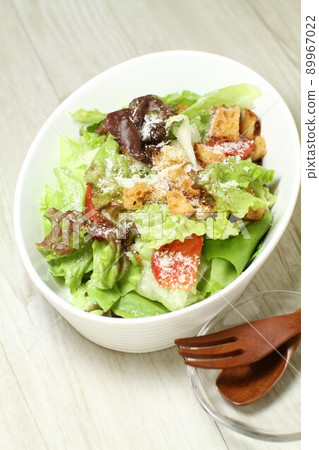 Lettuce salad, Caesar salad with plenty of grated cheese and savory croutons 89967022
