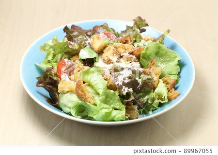 Caesar salad with lettuce salad, fragrant croutons and plenty of grated cheese 89967055