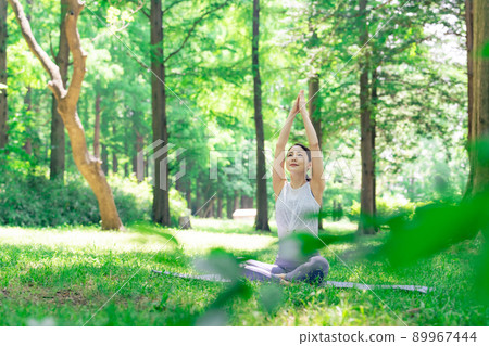 A woman doing yoga in the forest Forest Yoga Park Yoga 89967444