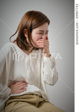 Young woman with food poisoning, nausea and abdominal pain Young woman with food poisoning, nausea and abdominal pain 89967783