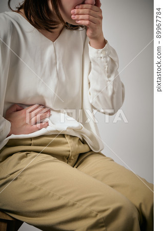 Young woman with food poisoning, nausea and abdominal pain Young woman with food poisoning, nausea and abdominal pain 89967784