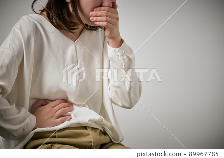 Young woman with food poisoning, nausea and abdominal pain 89967785