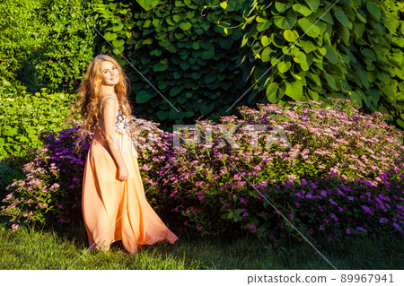 young girl standing and enjoying on summertime in the park young girl standing and enjoying on summertime in the park 89967941