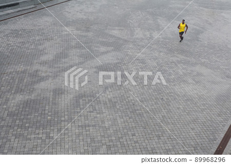 View from above. African man running at the morning. Outdoor shot, morning. Spring or summer View from above. African man running at the morning. Outdoor shot, morning. Spring or summer 89968296