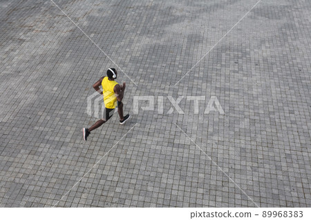 View from above. African man running at the morning. Outdoor shot, morning. Spring or summer 89968383