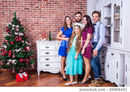 Best new year. Best friends in christmas time, have fun and looking at camera with toothy smile. Indoor, studio shot Best new year. Best friends in christmas time, have fun and looking at camera with toothy smile. Indoor, studio shot 89968483