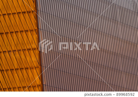 Reflection of sunset on the huge glass facade of skyscraper, wall of orange color Reflection of sunset on the huge glass facade of skyscraper, wall of orange color 89968592