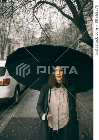Emotional portrait, girl with umbrella, emotion - reaction to surprise, fright Emotional portrait, girl with umbrella, emotion - reaction to surprise, fright 89968870